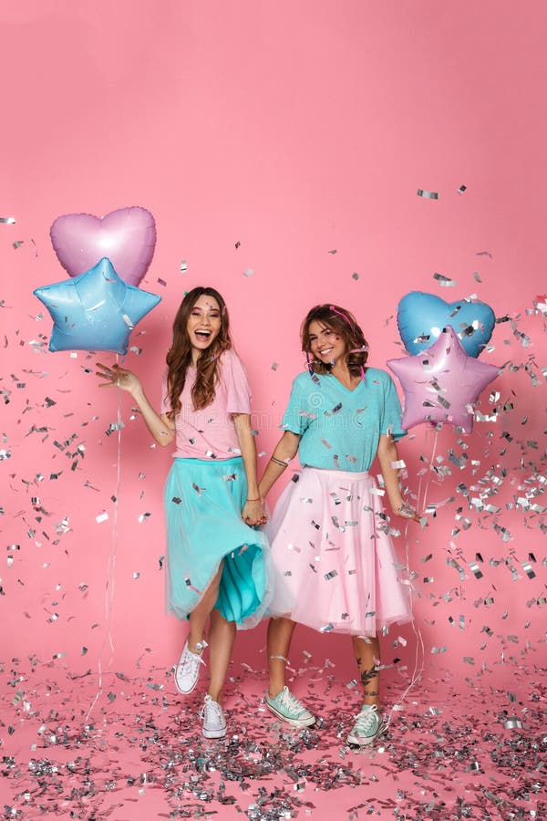 Volledige lengtefoto van twee gelukkige mooie meisjes met ballons cel royalty-vrije stock fotografie Volledige lengtefoto van twee gelukkige mooie meisjes met ballons cel royalty-vrije stock fotografie