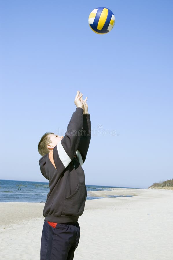 Volleyball boy on beach.