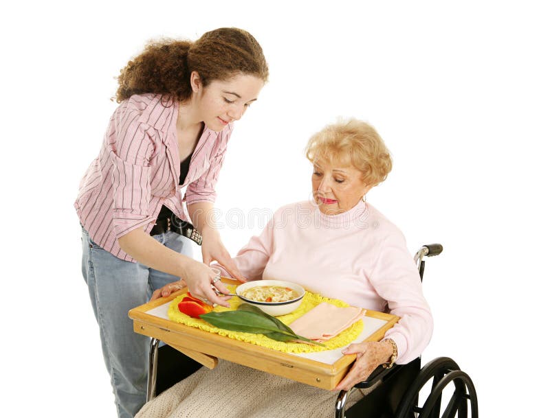 Teen volunteer brings lunch to a disabled senior woman. Isolated on white. Teen volunteer brings lunch to a disabled senior woman. Isolated on white.