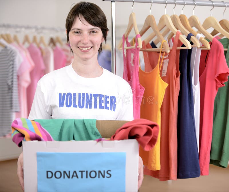 Volunteer with clothes donation box at second hand store. Volunteer with clothes donation box at second hand store