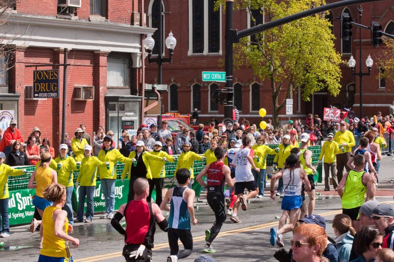 A group of volunteers hand out water to marathon participants at mile marker 10 during the 2010 Boston Marathon. A group of volunteers hand out water to marathon participants at mile marker 10 during the 2010 Boston Marathon