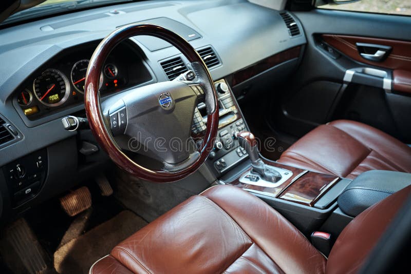 GRODNO, BELARUS - MAY 2015: Volvo XC90 4.4 v8 1st generation restyling 4WD SUV premium car interior brown leather with forest view closeup from driver side. GRODNO, BELARUS - MAY 2015: Volvo XC90 4.4 v8 1st generation restyling 4WD SUV premium car interior brown leather with forest view closeup from driver side