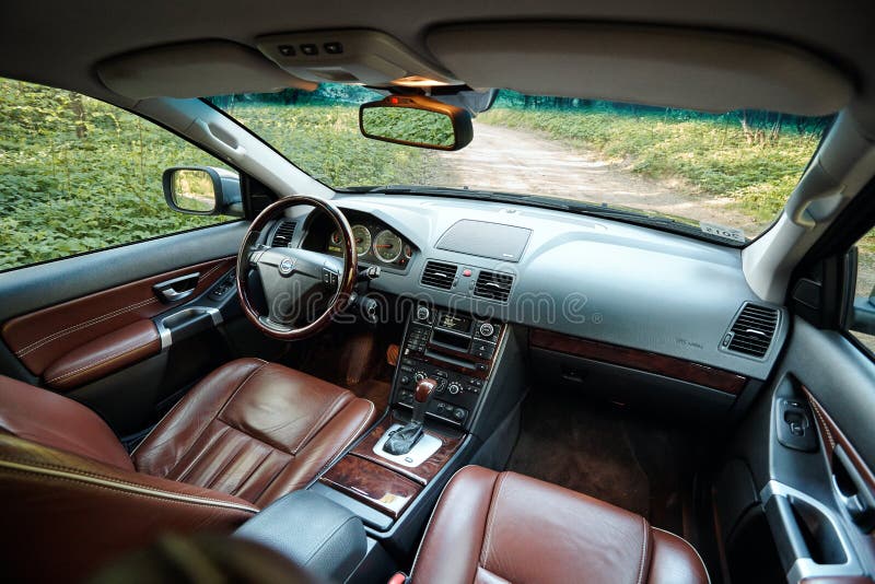 GRODNO, BELARUS - MAY 2015: Volvo XC90 4.4 v8 1st generation restyling 4WD SUV premium car interior brown leather with forest view. GRODNO, BELARUS - MAY 2015: Volvo XC90 4.4 v8 1st generation restyling 4WD SUV premium car interior brown leather with forest view