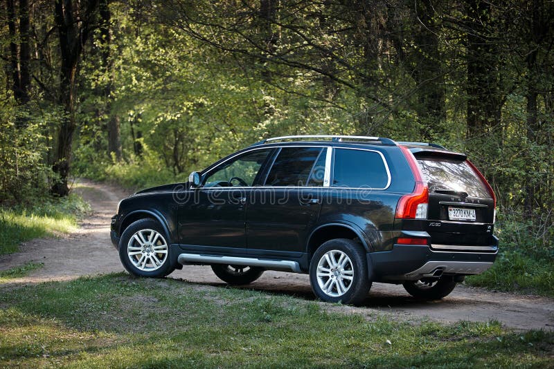 GRODNO, BELARUS - MAY 2015: Volvo XC90 4.4 v8 1st generation restyling 4WD SUV test drive in spring forest country road side view in Grodno Belarus. GRODNO, BELARUS - MAY 2015: Volvo XC90 4.4 v8 1st generation restyling 4WD SUV test drive in spring forest country road side view in Grodno Belarus