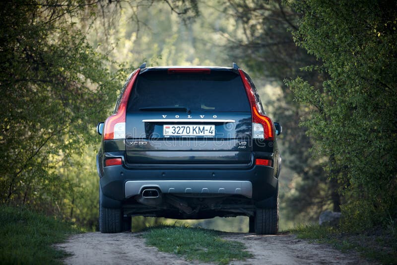 GRODNO, BELARUS - MAY 2015: Volvo XC90 4.4 v8 1st generation restyling 4WD SUV test drive in spring country road on forest background back view in Grodno Belarus. GRODNO, BELARUS - MAY 2015: Volvo XC90 4.4 v8 1st generation restyling 4WD SUV test drive in spring country road on forest background back view in Grodno Belarus