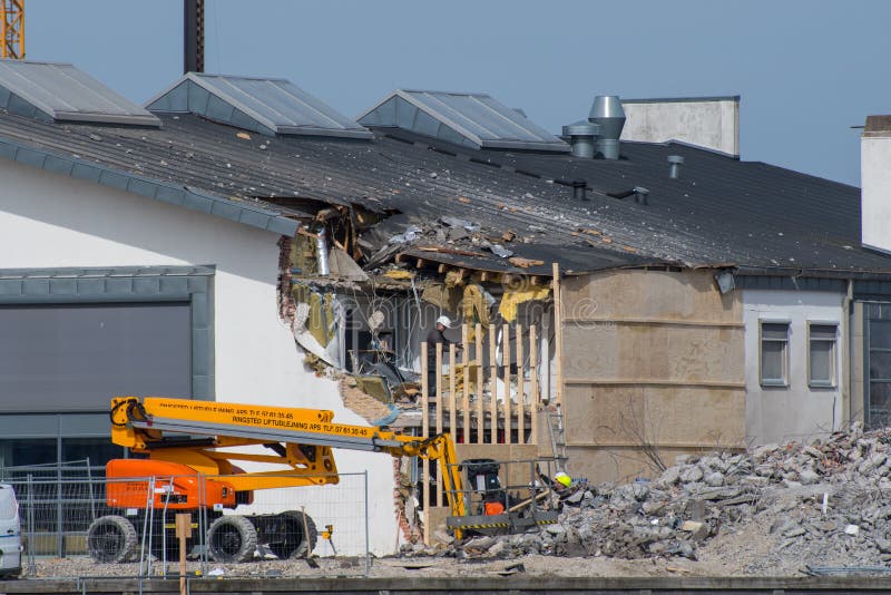 Vordingborg Denmark - April 7. 2018: construction workers making repairs on the library in Vordingborg after failed demolition of the next building