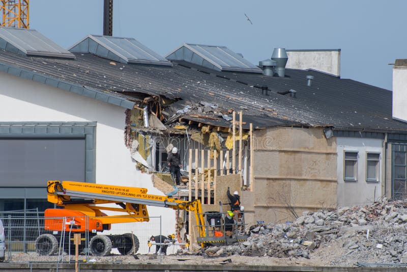 Vordingborg Denmark - April 7. 2018: construction workers making repairs on the library in Vordingborg after failed demolition of the next building