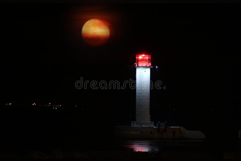 Vorontsov Lighthouse night against the rising of the big red moon. stock photo Vorontsov Lighthouse night against the rising of the big red moon. stock photo