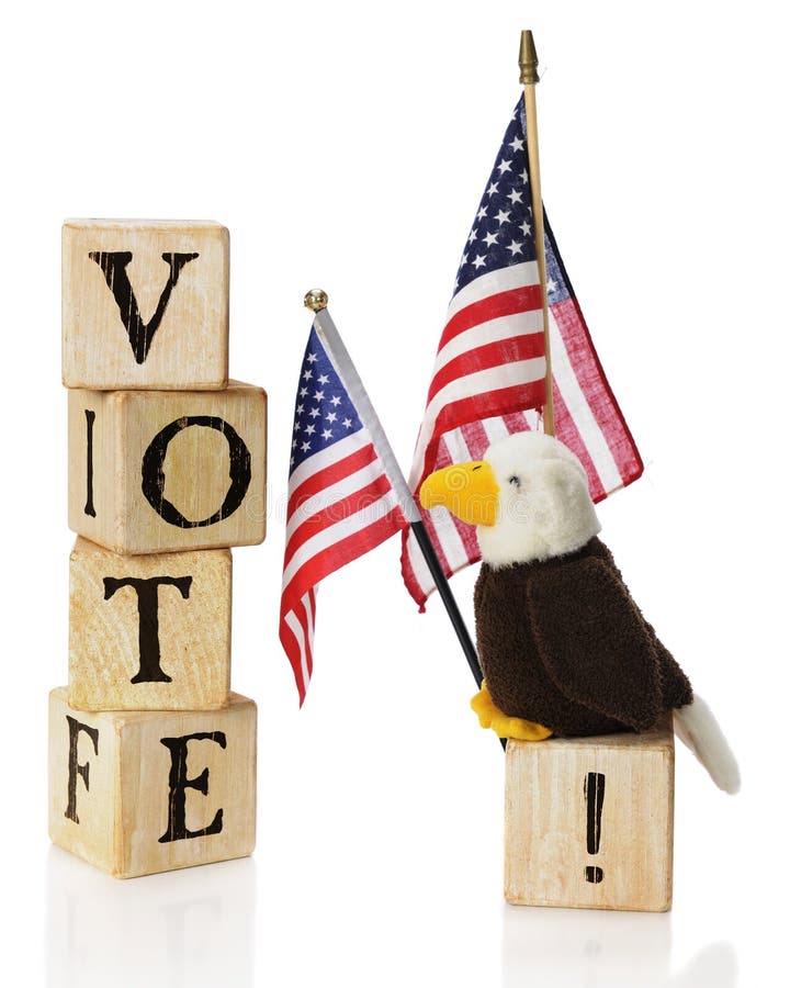 Vote, USA. A toy bald eagle looking at the word VOTE constructed of rustic alphabet block, while he's perched on an exclaimation point by two US flags. On a stock photos Vote, USA. A toy bald eagle looking at the word VOTE constructed of rustic alphabet block, while he's perched on an exclaimation point by two US flags. On a stock photos