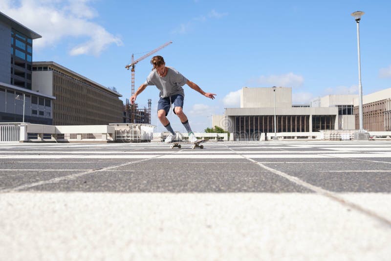 Voyage d'homme et ville avec skateboard sur l'asphalte pour tromper la cascade extrême ou l'habileté dans une ville ou un parc de photo stock