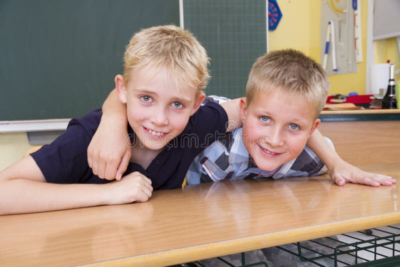 Two small friends in a yellow classroom. Two small friends in a yellow classroom.