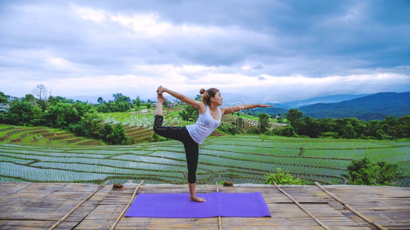 Freedom traveler woman relax in the holiday. Play if yoga Stand landscapes natural on the mountains and Field Rice. Freedom traveler woman relax in the holiday. Play if yoga Stand landscapes natural on the mountains and Field Rice.