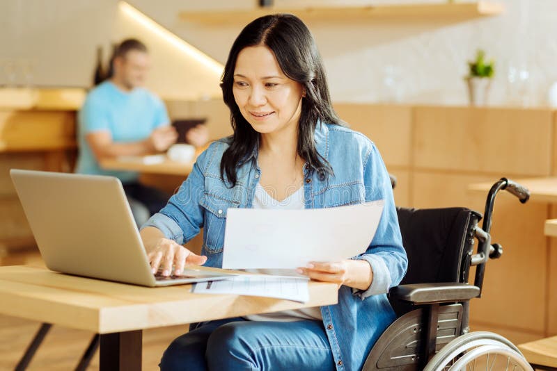 Vrolijke gehandicapte vrouw die een blad van document houden stock afbeeldingen Vrolijke gehandicapte vrouw die een blad van document houden stock afbeeldingen
