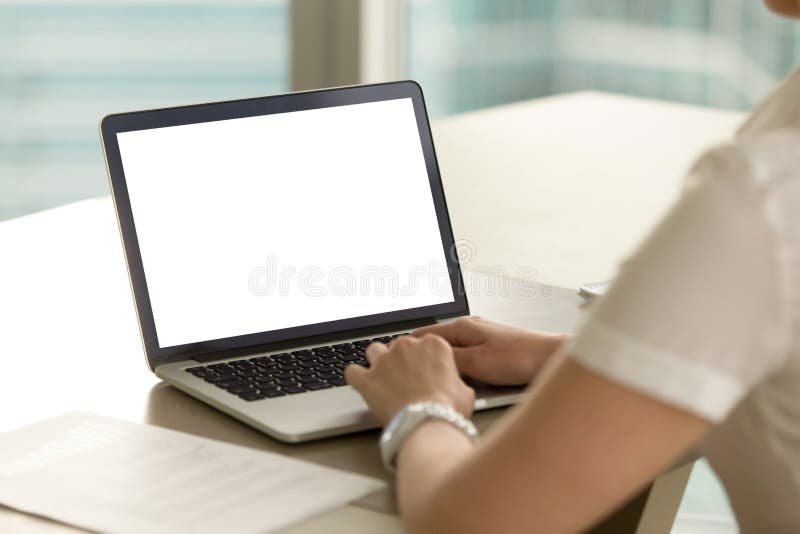 Business woman in office working on laptop with mockup blank screen. Empty copy space on monitor for business advertisement, corporate website, company financial report. Close up view over shoulder. Business woman in office working on laptop with mockup blank screen. Empty copy space on monitor for business advertisement, corporate website, company financial report. Close up view over shoulder.