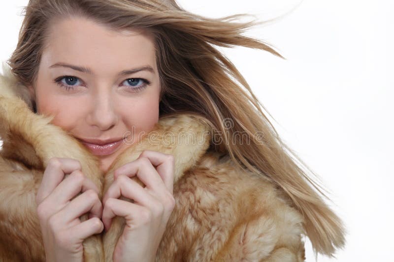 Woman wearing a comfortable fur coat. Woman wearing a comfortable fur coat