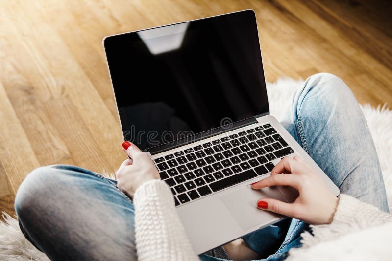 Top view of a young woman with a computer on her lap. Top view of a young woman with a computer on her lap