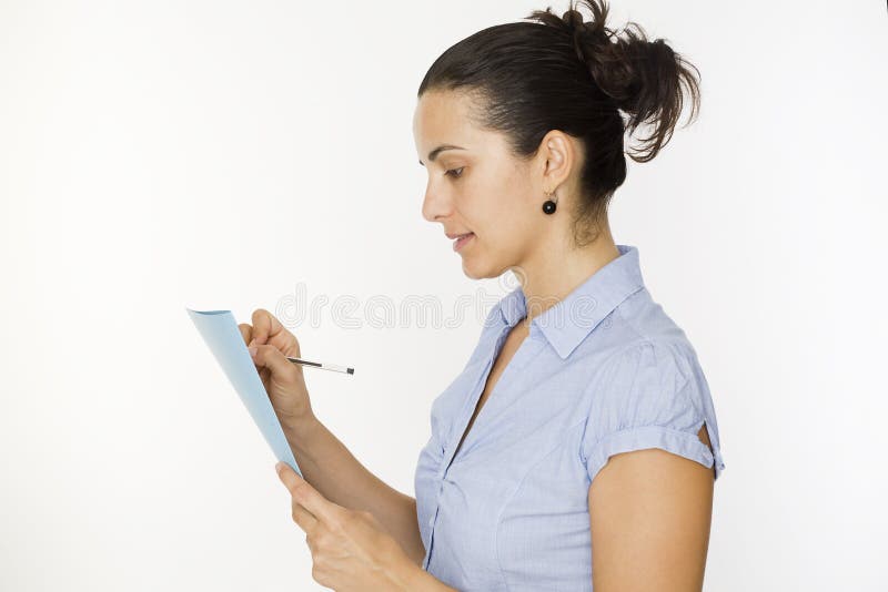 Woman taking note in her writing pad. Woman taking note in her writing pad