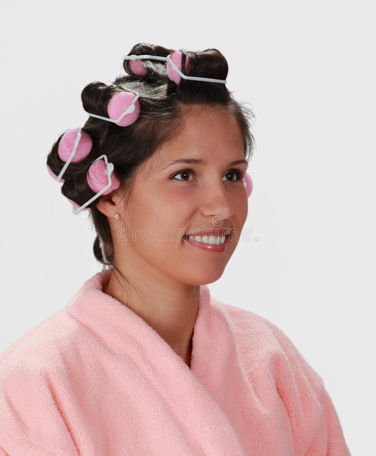 Portrait of a young woman with hair curlers on her head. Portrait of a young woman with hair curlers on her head.