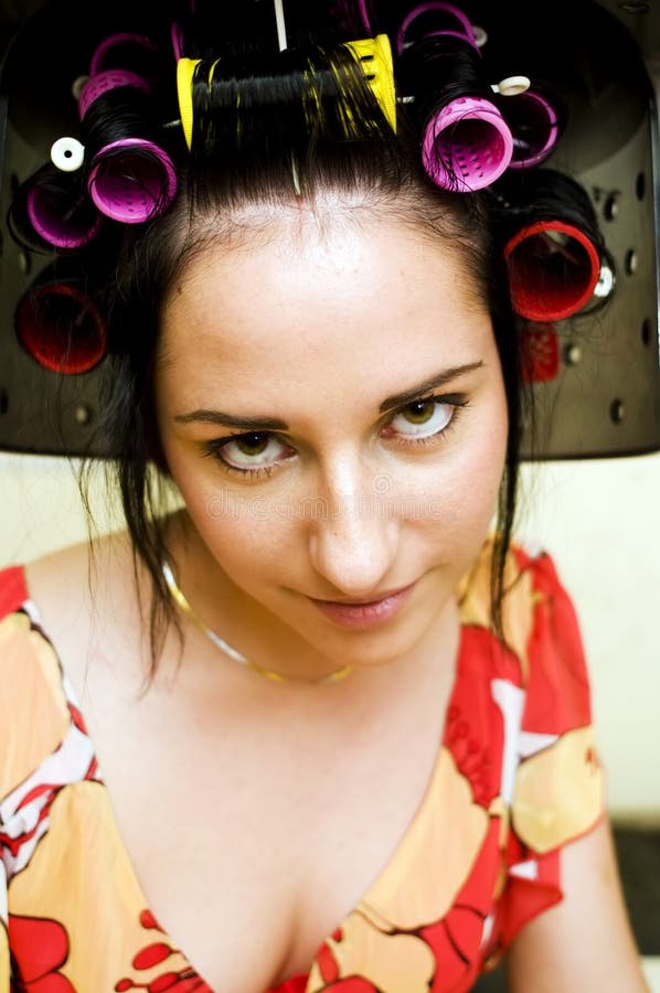 Portrait of the beautiful woman with curlers. Portrait of the beautiful woman with curlers