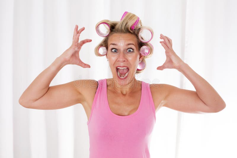 Blond woman with pink curlers is screaming. Blond woman with pink curlers is screaming