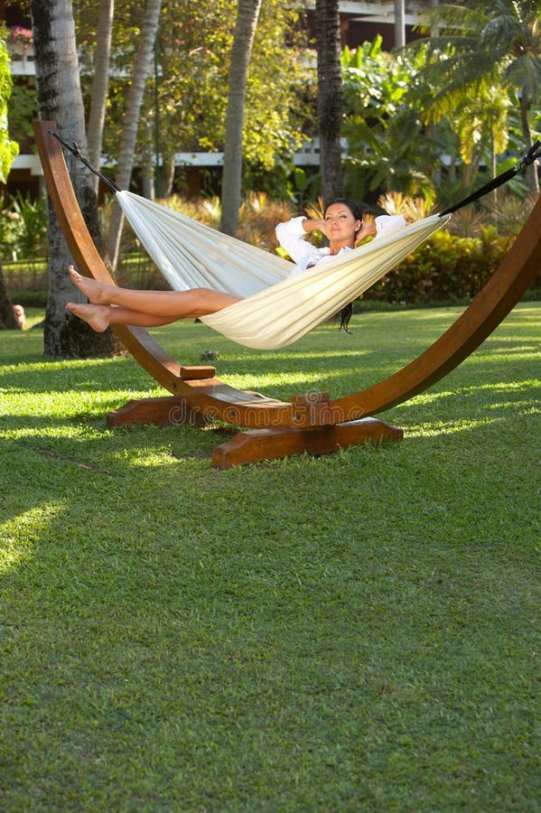 20-25 years woman portrait ralaxing on hammock at exotic surrounding, bali indonesia. 20-25 years woman portrait ralaxing on hammock at exotic surrounding, bali indonesia