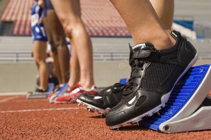 Vrouwelijke Atleet On Starting Blocks stock foto's Vrouwelijke Atleet On Starting Blocks stock foto's