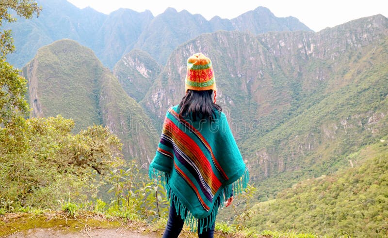 Female traveler being impressed with the breathtaking view of mountain range seen from Huayna Picchu mountain, Cusco Region, Peru, South America. Female traveler being impressed with the breathtaking view of mountain range seen from Huayna Picchu mountain, Cusco Region, Peru, South America