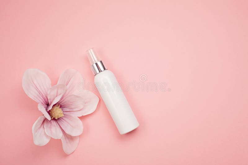 Feminine beauty and spa product and cosmetics over the millennial pink background. Feminine beauty and spa product and cosmetics over the millennial pink background