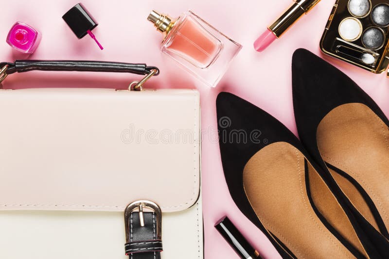 Women`s accessories - shoes, bag, cosmetics, perfume on pink background. Feminine and fashion background. Top view. Women`s accessories - shoes, bag, cosmetics, perfume on pink background. Feminine and fashion background. Top view.