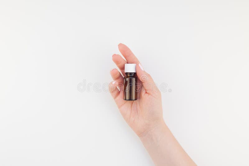 Vrouwenhand met klein glazen flesje geïsoleerd stock foto's