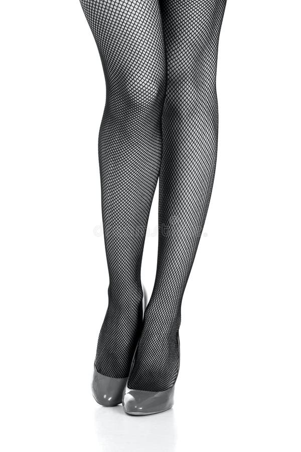 Beautiful woman legs in nets stockings isolated on white background. Beautiful woman legs in nets stockings isolated on white background