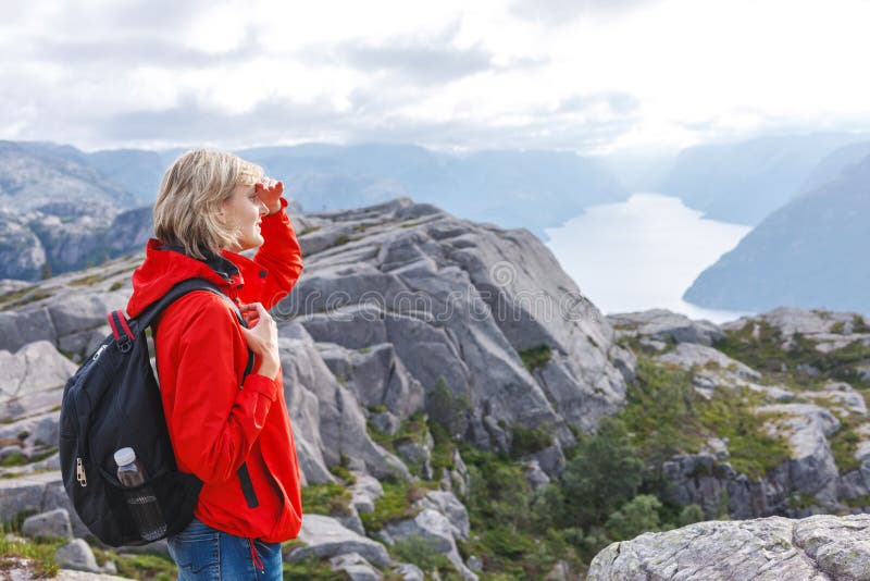 Vrouwenwandelaar op Preekstoelrots/Preikestolen, Noorwegen stock foto Vrouwenwandelaar op Preekstoelrots/Preikestolen, Noorwegen stock foto
