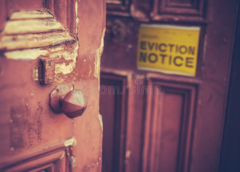 Grungy Old Door With A Yellow Eviction Notice. Grungy Old Door With A Yellow Eviction Notice