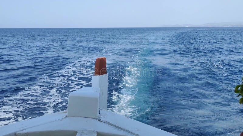 Vue arrière d'un bateau flottant sur l'étonnante eau bleue claire banque de vidéos