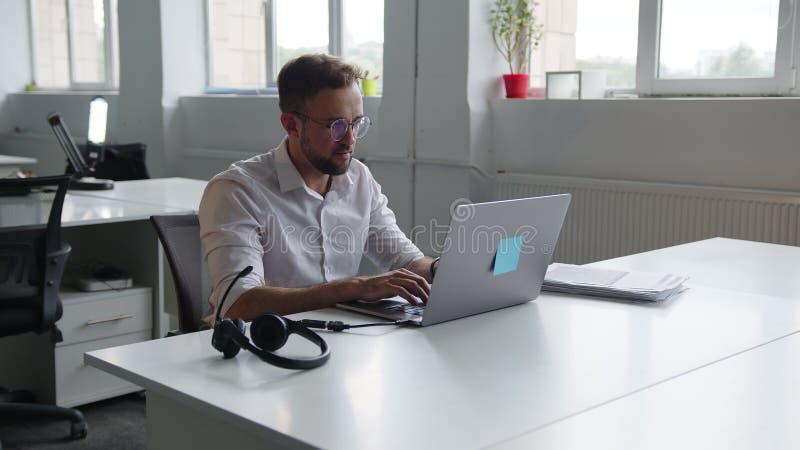Vue arrière d'un homme assis sur l'ordinateur portable gris clips vidéos