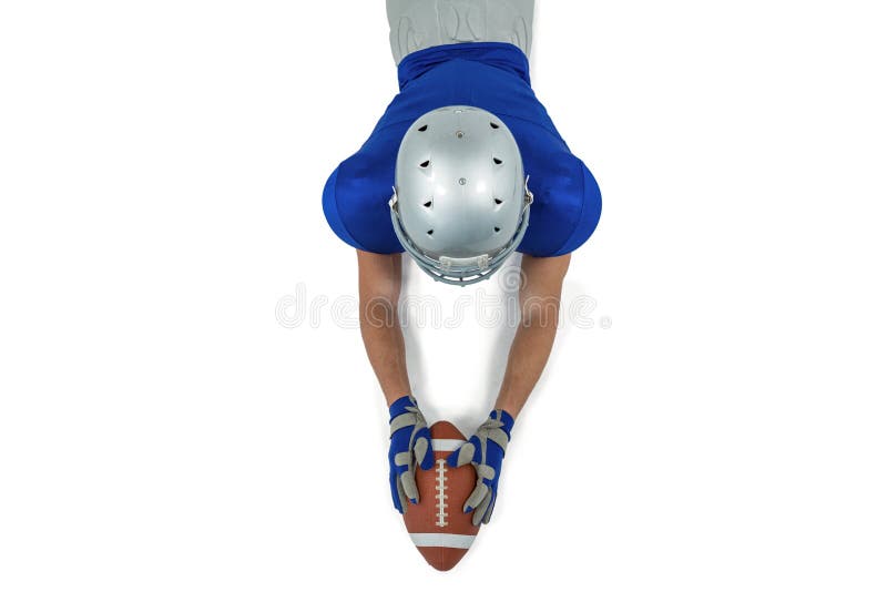 Vue arrière de joueur de football américain atteignant vers la boule images stock Vue arrière de joueur de football américain atteignant vers la boule images stock