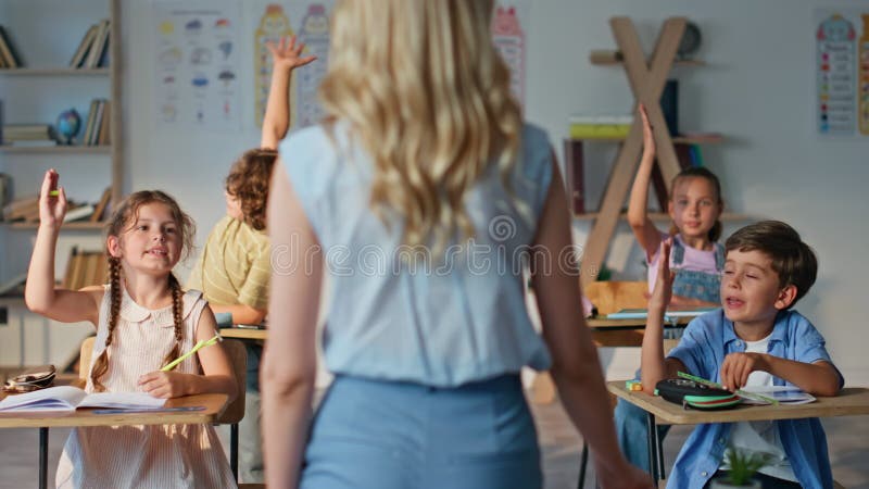 Vue arrière du groupe de classes communicantes par l'enseignant. éducateur méconnaissable demandant banque de vidéos