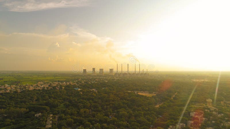 Vue aérienne de la centrale à charbon - Fumée des usines Chimnys - lever de soleil dans une ville verte couverte avec des usines image libre de droits Vue aérienne de la centrale à charbon - Fumée des usines Chimnys - lever de soleil dans une ville verte couverte avec des usines image libre de droits