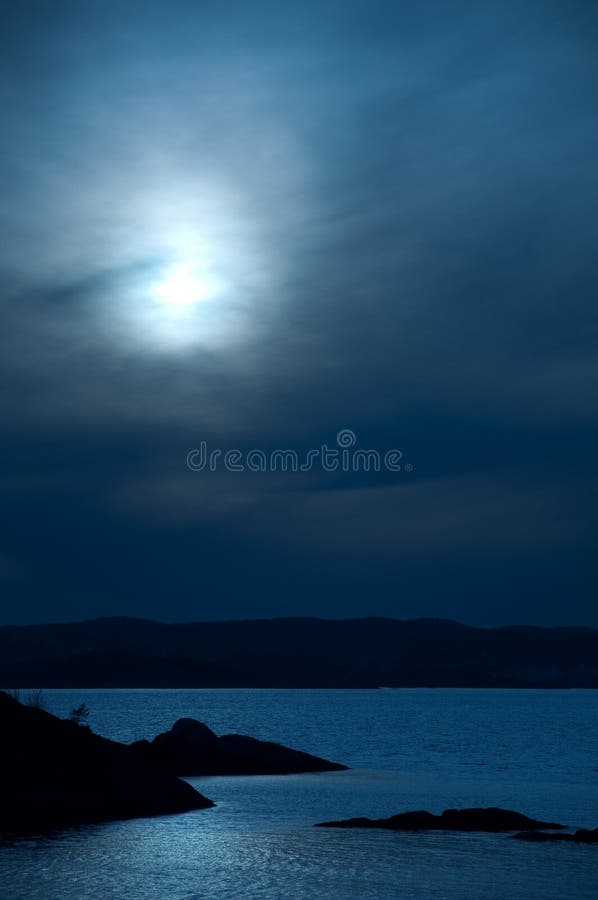 Scenic ocean view in the moonlight with hills in the background. Scenic ocean view in the moonlight with hills in the background