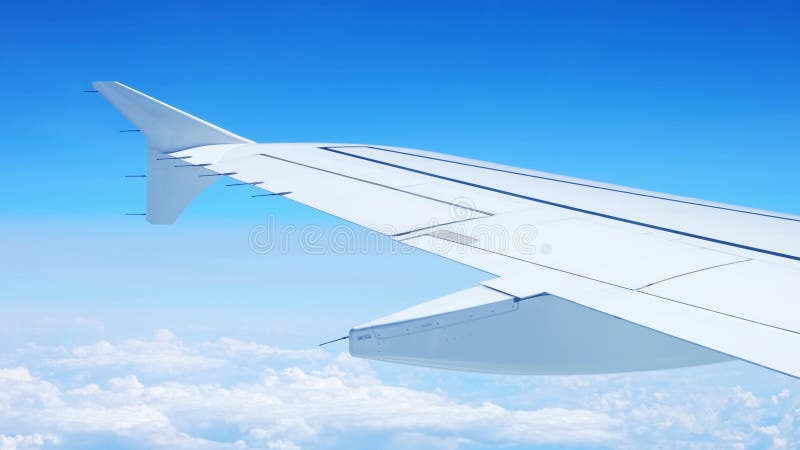 Vue d'une aile d'avion d'un hublot sur fond bleu ciel. un avion de transport vole au-dessus des nuages dans banque de vidéos