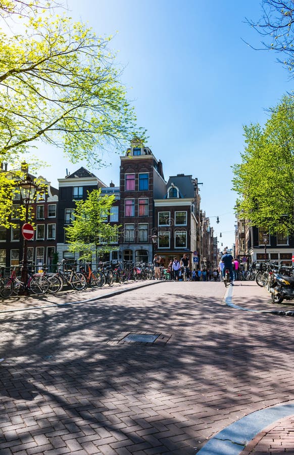 Vue d'une petite place de ville et d'un pont au-dessus du canal d'Amstel à Amsterdam, Pays-Bas image libre de droits Vue d'une petite place de ville et d'un pont au-dessus du canal d'Amstel à Amsterdam, Pays-Bas image libre de droits