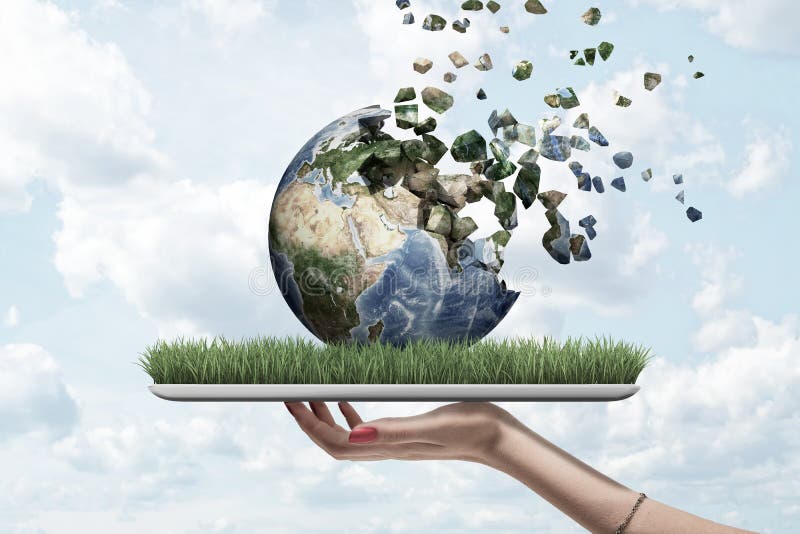 Side view of woman`s hand holding tablet with green grass on screen and Earth globe on top which is dissolving into pieces that float away into sky. Raise awareness. Earth in danger. Help save planet. Side view of woman`s hand holding tablet with green grass on screen and Earth globe on top which is dissolving into pieces that float away into sky. Raise awareness. Earth in danger. Help save planet.