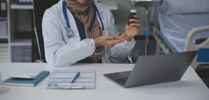 Cropped view of doctor in white coat holding bottle medication, prescribing pills to sick patient via online consultation. Family therapist recommend quality medicines. Healthcare, treatment concept. Cropped view of doctor in white coat holding bottle medication, prescribing pills to sick patient via online consultation. Family therapist recommend quality medicines. Healthcare, treatment concept