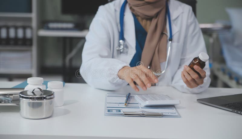 Cropped view of doctor in white coat holding bottle medication, prescribing pills to sick patient via online consultation. Family therapist recommend quality medicines. Healthcare, treatment concept. Cropped view of doctor in white coat holding bottle medication, prescribing pills to sick patient via online consultation. Family therapist recommend quality medicines. Healthcare, treatment concept