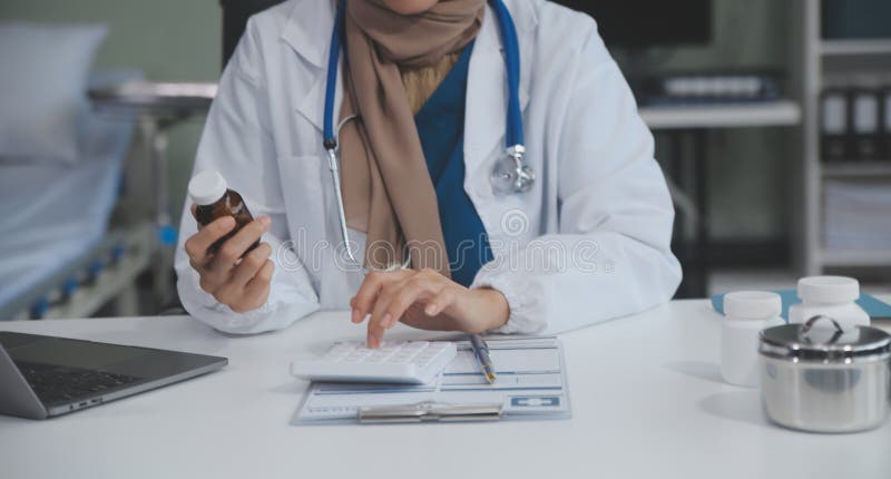 Cropped view of doctor in white coat holding bottle medication, prescribing pills to sick patient via online consultation. Family therapist recommend quality medicines. Healthcare, treatment concept. Cropped view of doctor in white coat holding bottle medication, prescribing pills to sick patient via online consultation. Family therapist recommend quality medicines. Healthcare, treatment concept