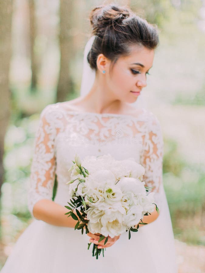 Vue en gros plan du bouqut de mariage des pivoines blanches dans les mains de la jeune mariée images libres de droits