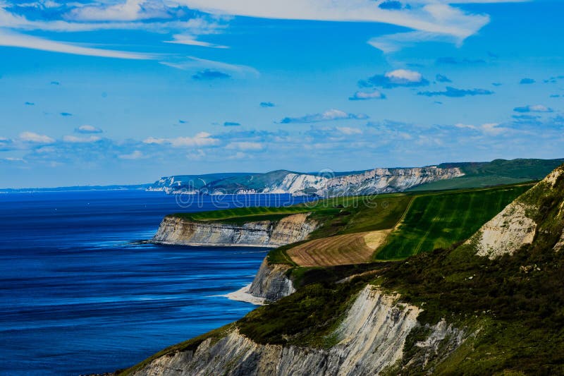 Coastal cliffs by the ocean with grassy surroundings. Coastal cliffs by the ocean with grassy surroundings