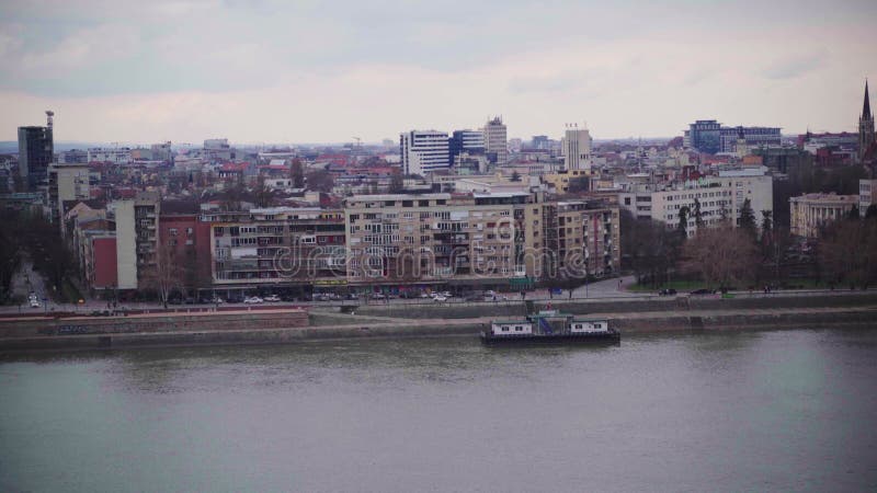 Vue panoramique de la rivière urbaine avec pont et paysage urbain sous ciel nuageux banque de vidéos