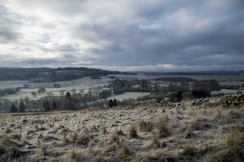 Wide angle view over a frosty Northumberland valley in winter. Taken from the forestry trails above Falstone village near Kielder Resevoir. Wide angle view over a frosty Northumberland valley in winter. Taken from the forestry trails above Falstone village near Kielder Resevoir.