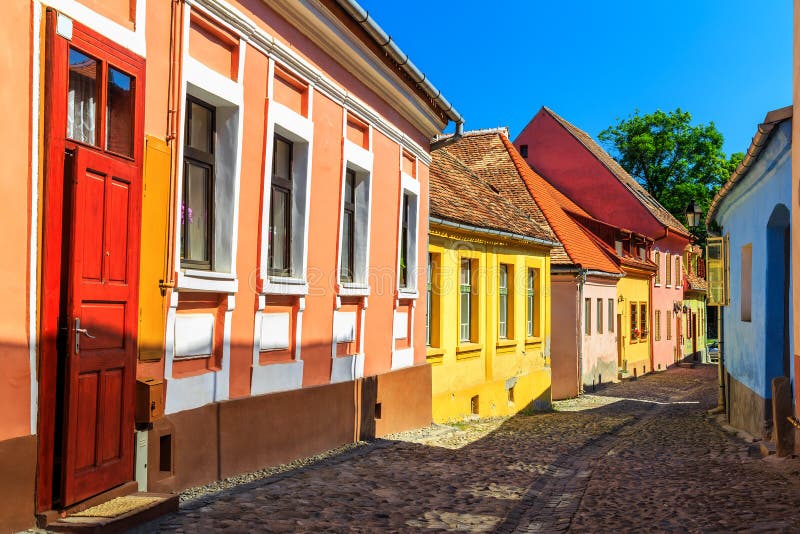 Stone paved old streets with colorful houses in Sighisoara fortress,Transylvania,Romania,Europe. Stone paved old streets with colorful houses in Sighisoara fortress,Transylvania,Romania,Europe